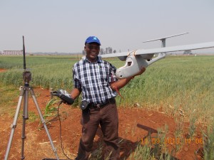 Charles Mutimaamba, Chief Research Officer and Maize Breeder at the CBI, pauses for a photo with the Skywalker in a field.